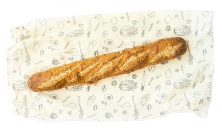 Image of Abeego Beeswax wrap with a baguette on top, a helpful tool for zero waste entertaining
