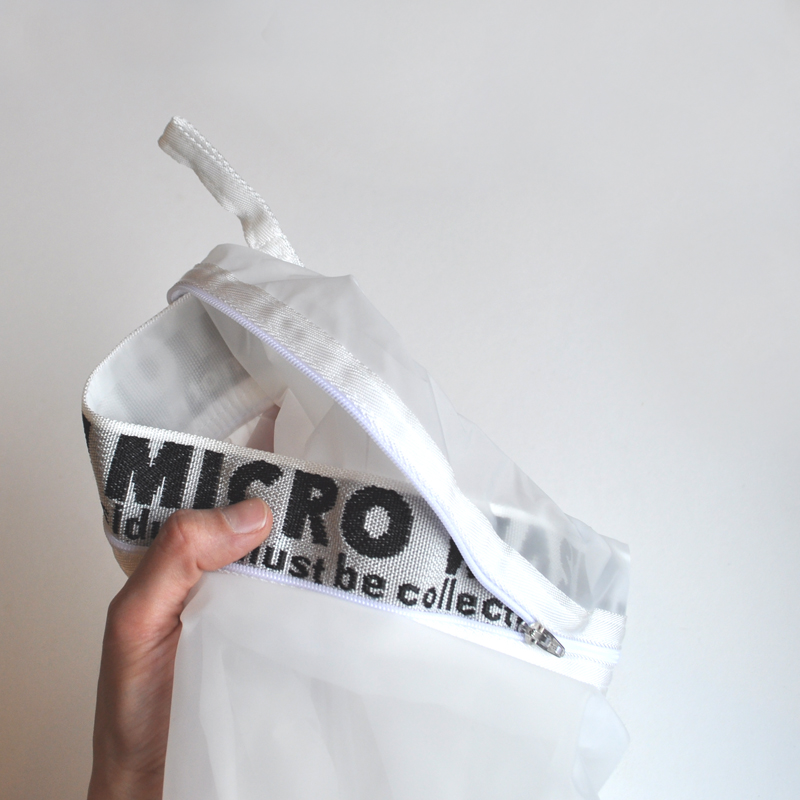 Image of a hand holding up a microfiber washing bag