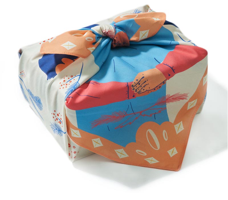 Image of a present wrapped in a traditional furoshiki cloth, an infinitely and eco friendly wrapping paper