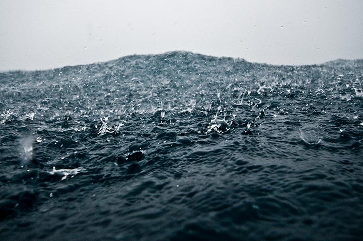 Image of rain drops falling into the ocean