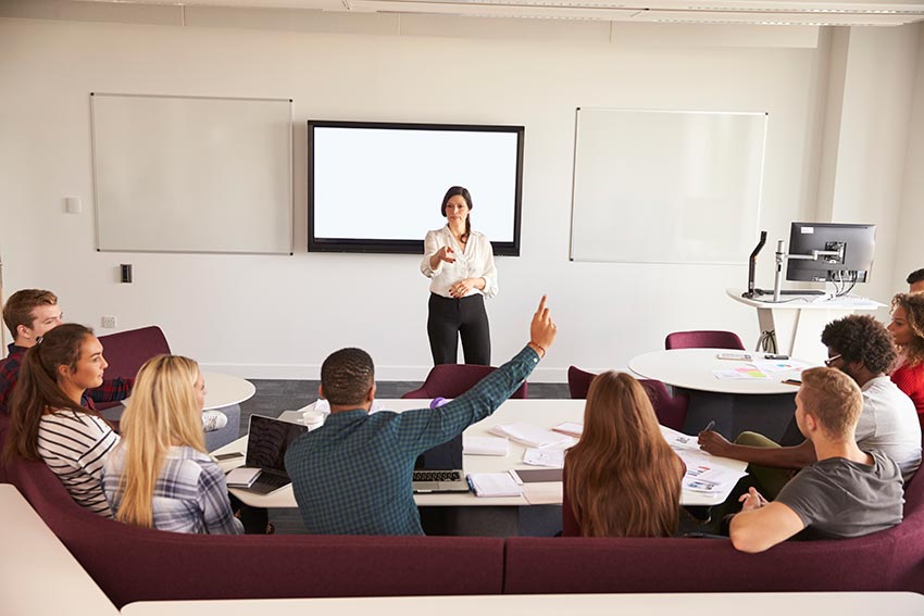 Image of a college classroom lead by a female professor